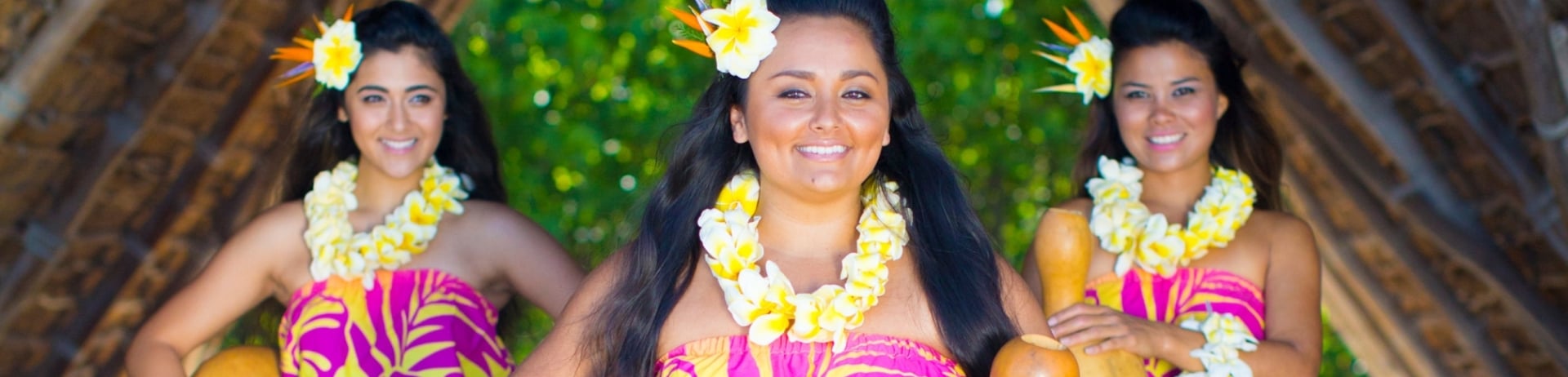 three women in Lūʻau attire