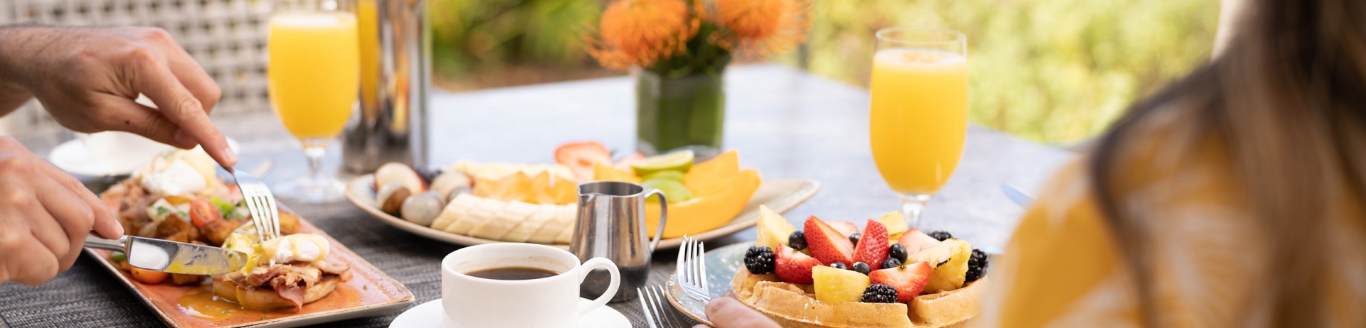 a person eating waffles and orange juice