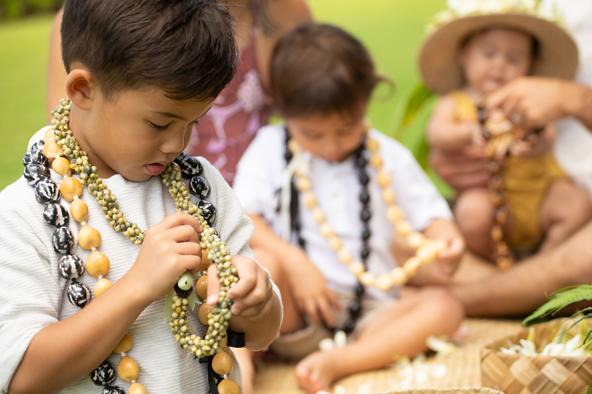 a child wearing multiple leis