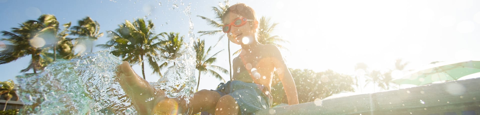 a little boy splashing in the water