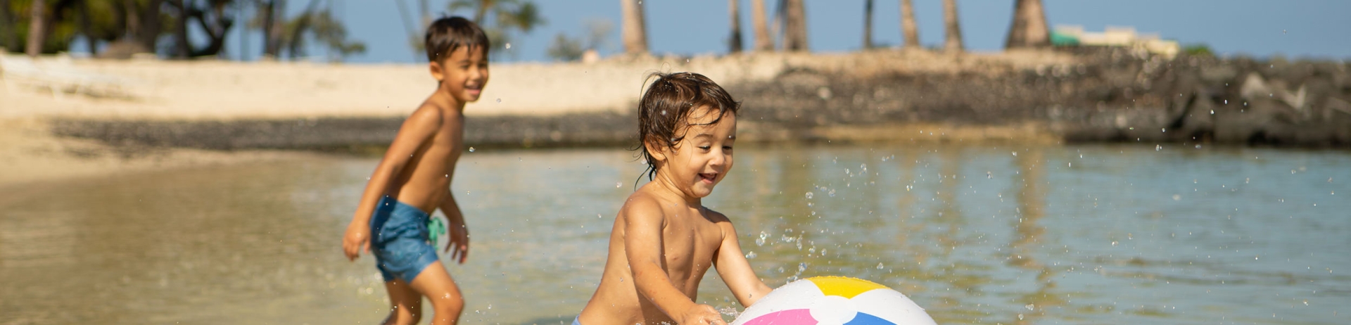 two children playing with a beach ball