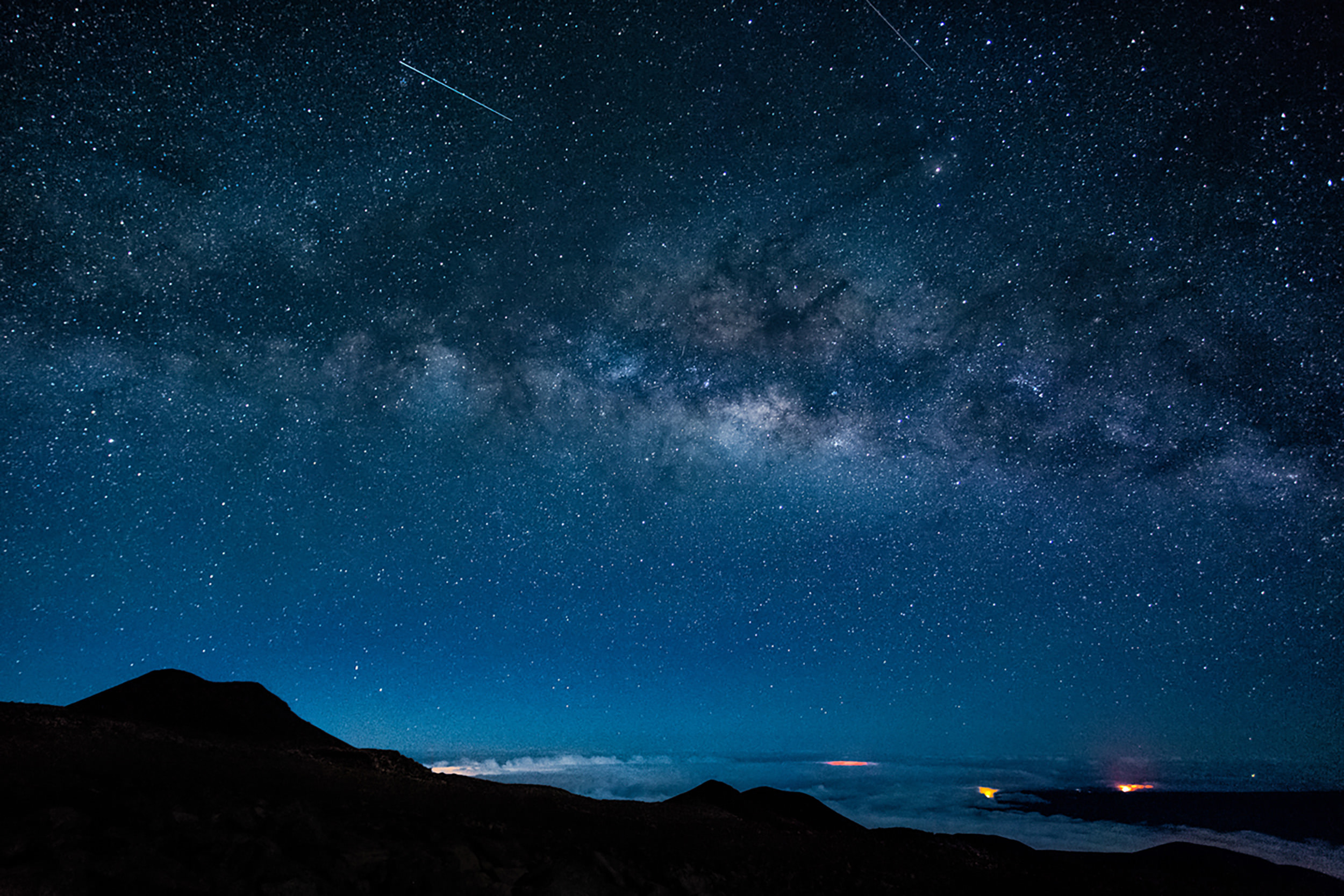 shooting stars above the ocean