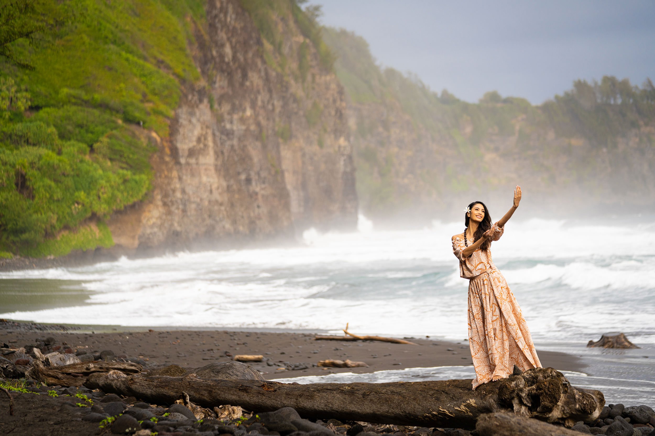 a woman on the beach hula dancing