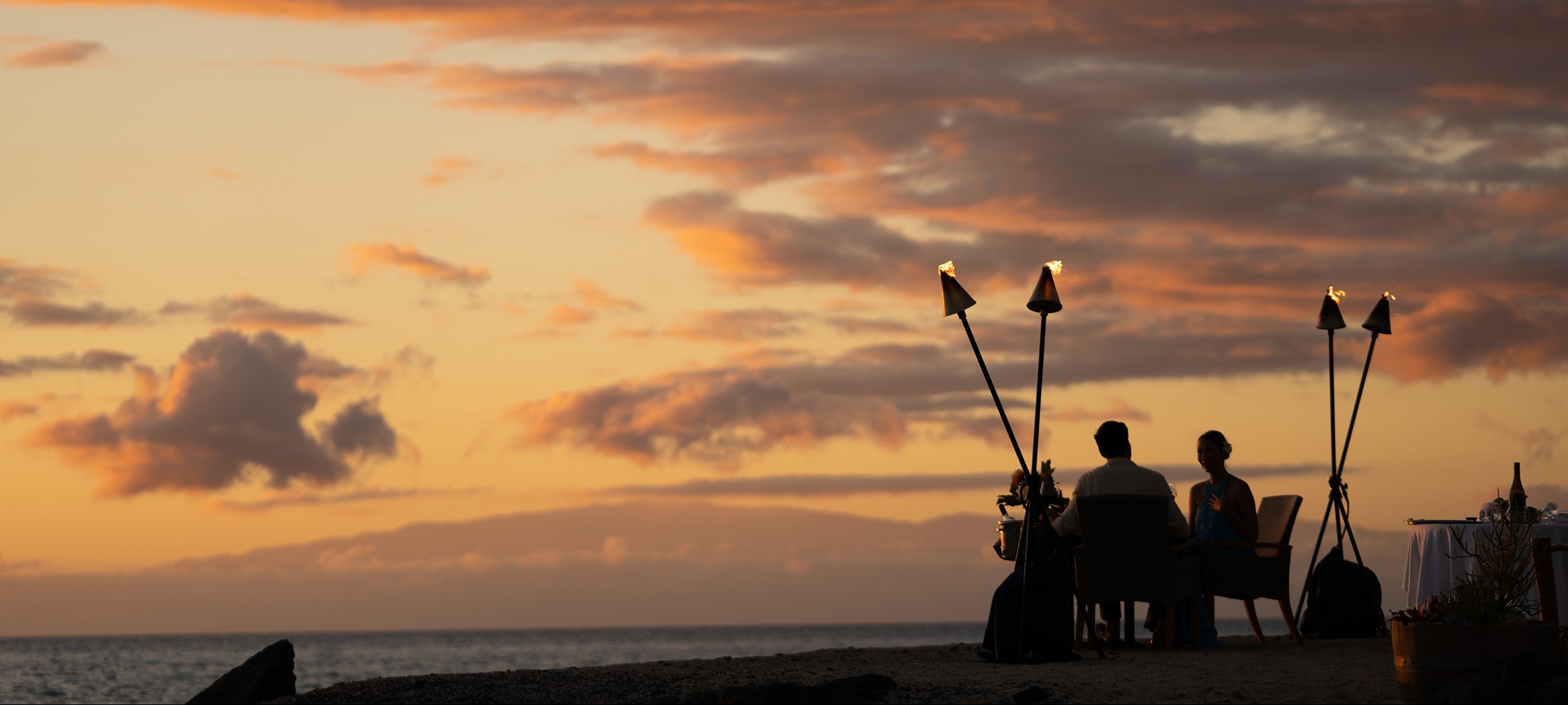 couple watching the sunset on the beach