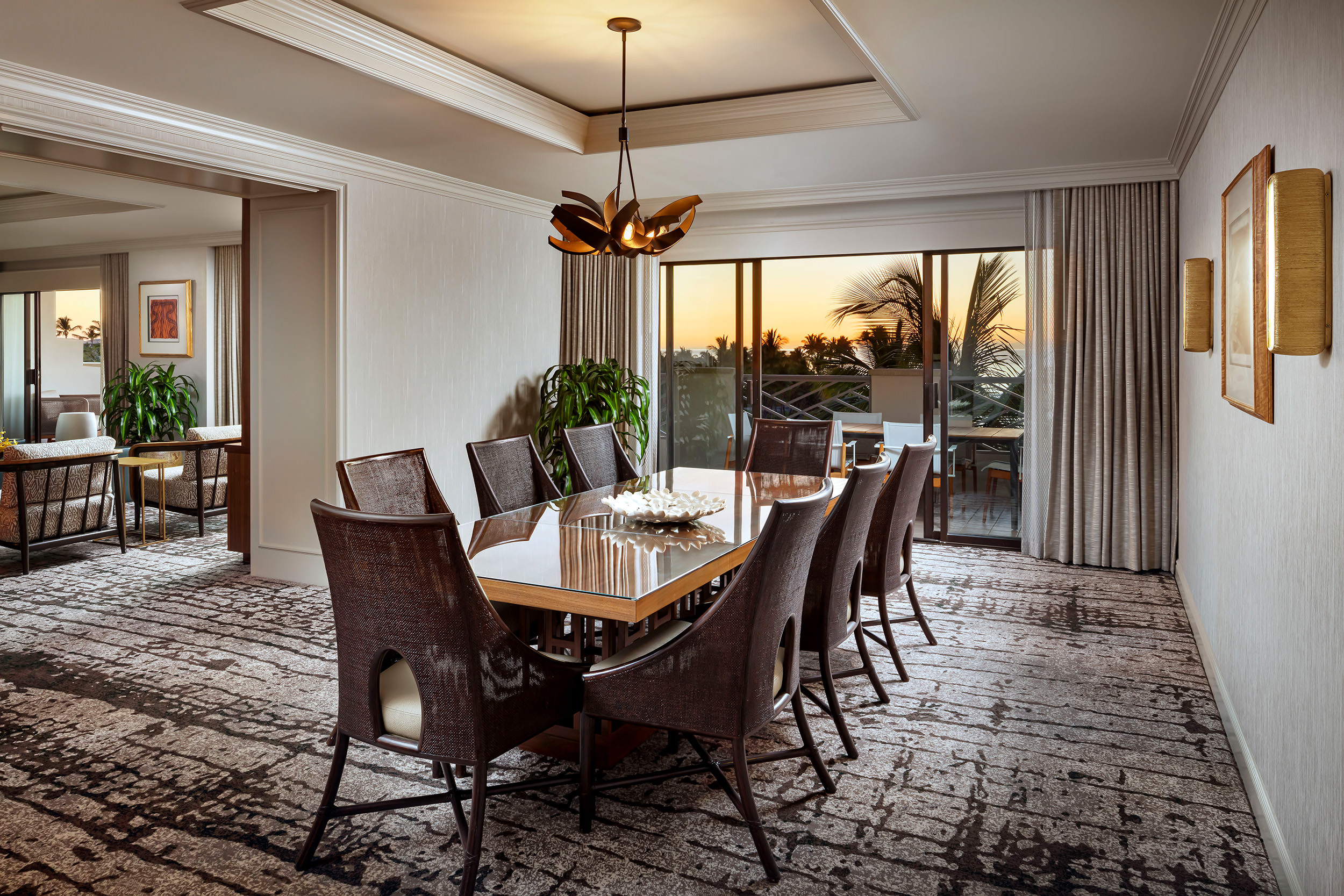 Dining room table with view of balcony during sunset