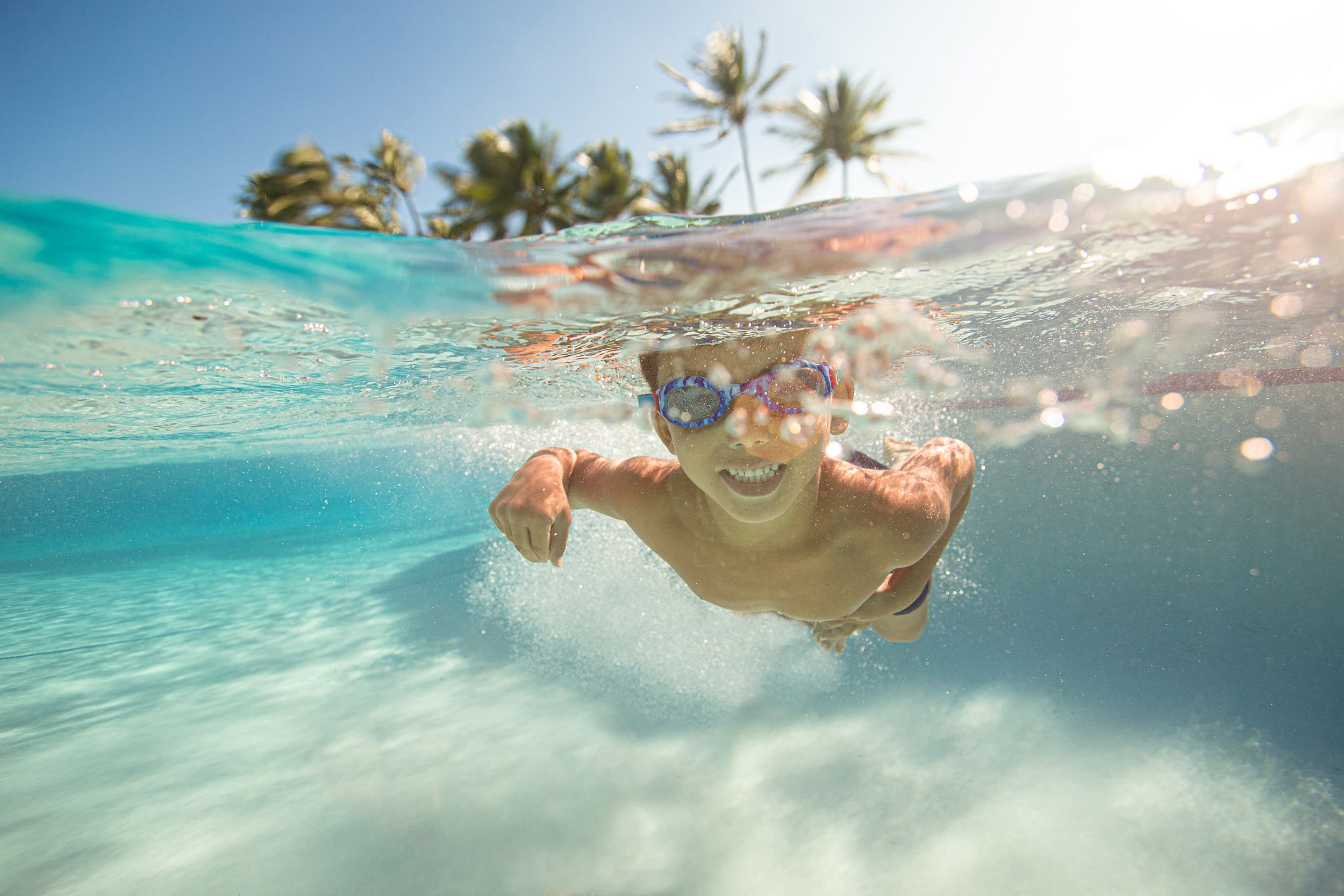 boy swimming under water