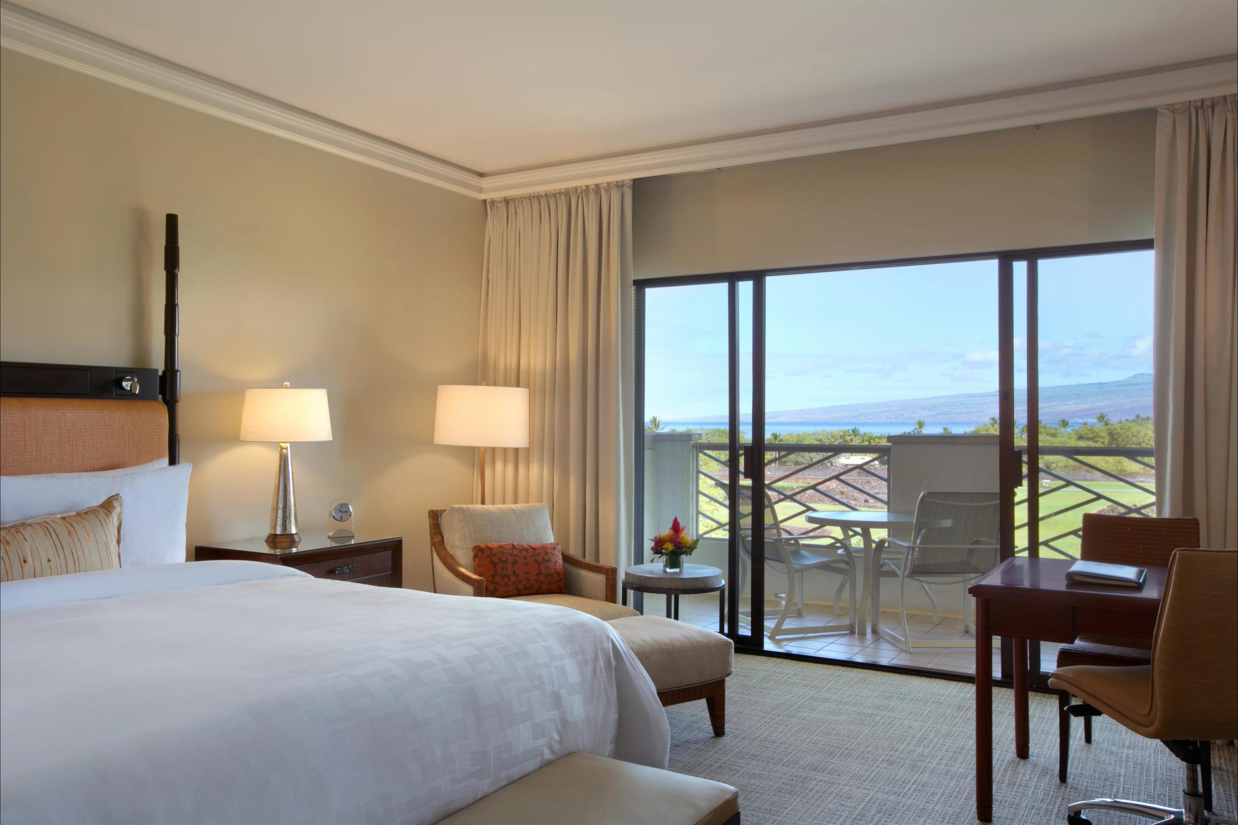 bedroom with balcony and view of ocean