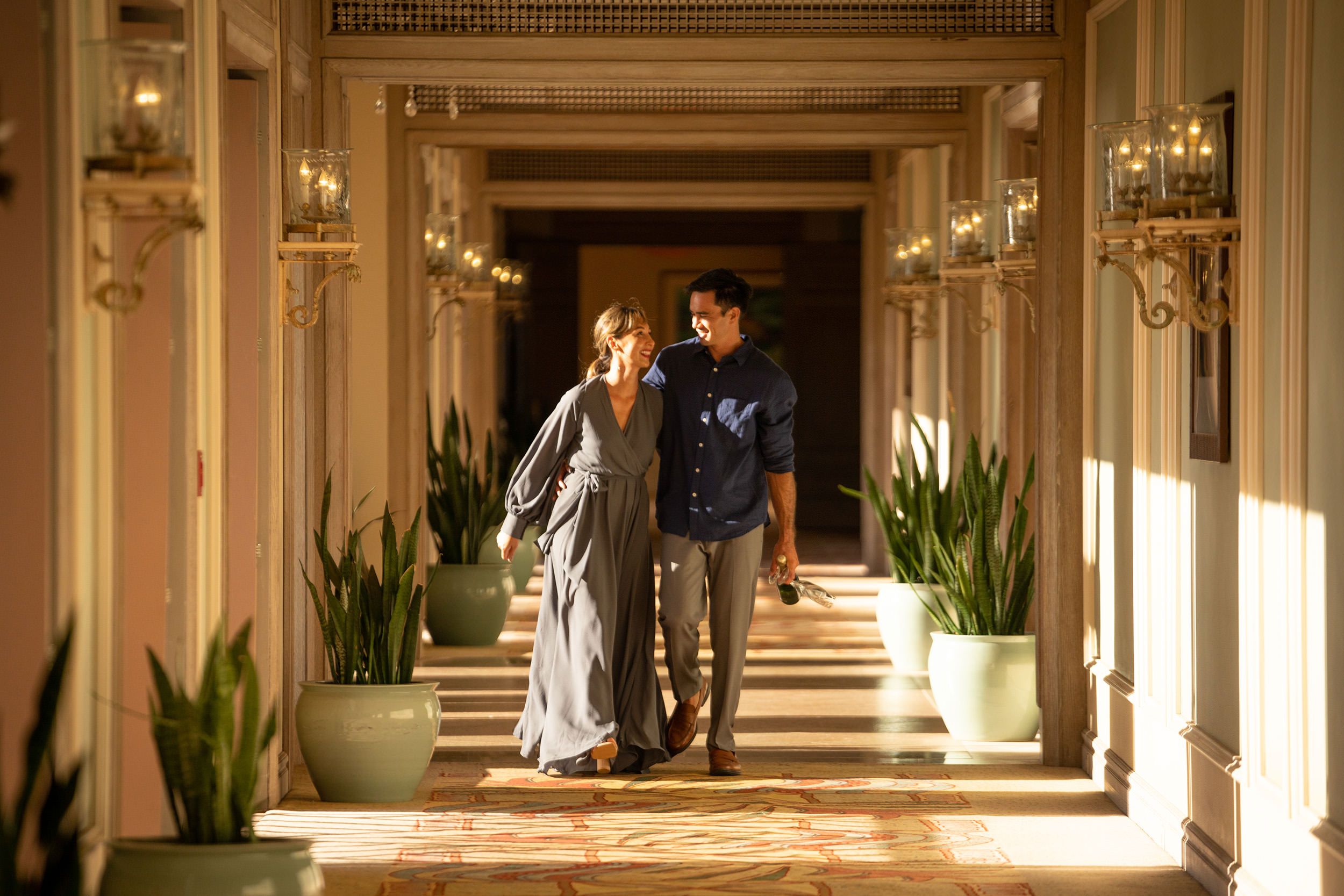 a couple walking down a hallway