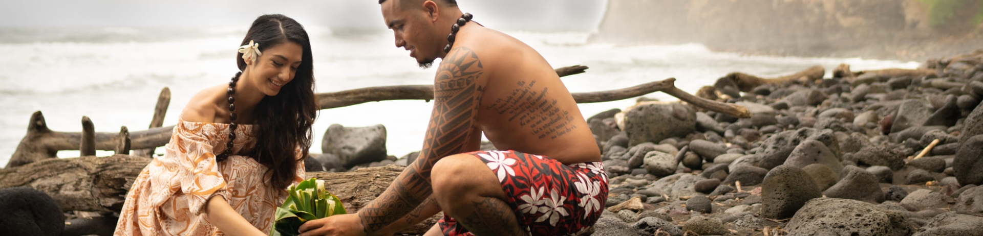 two people creating a bundle of leaves