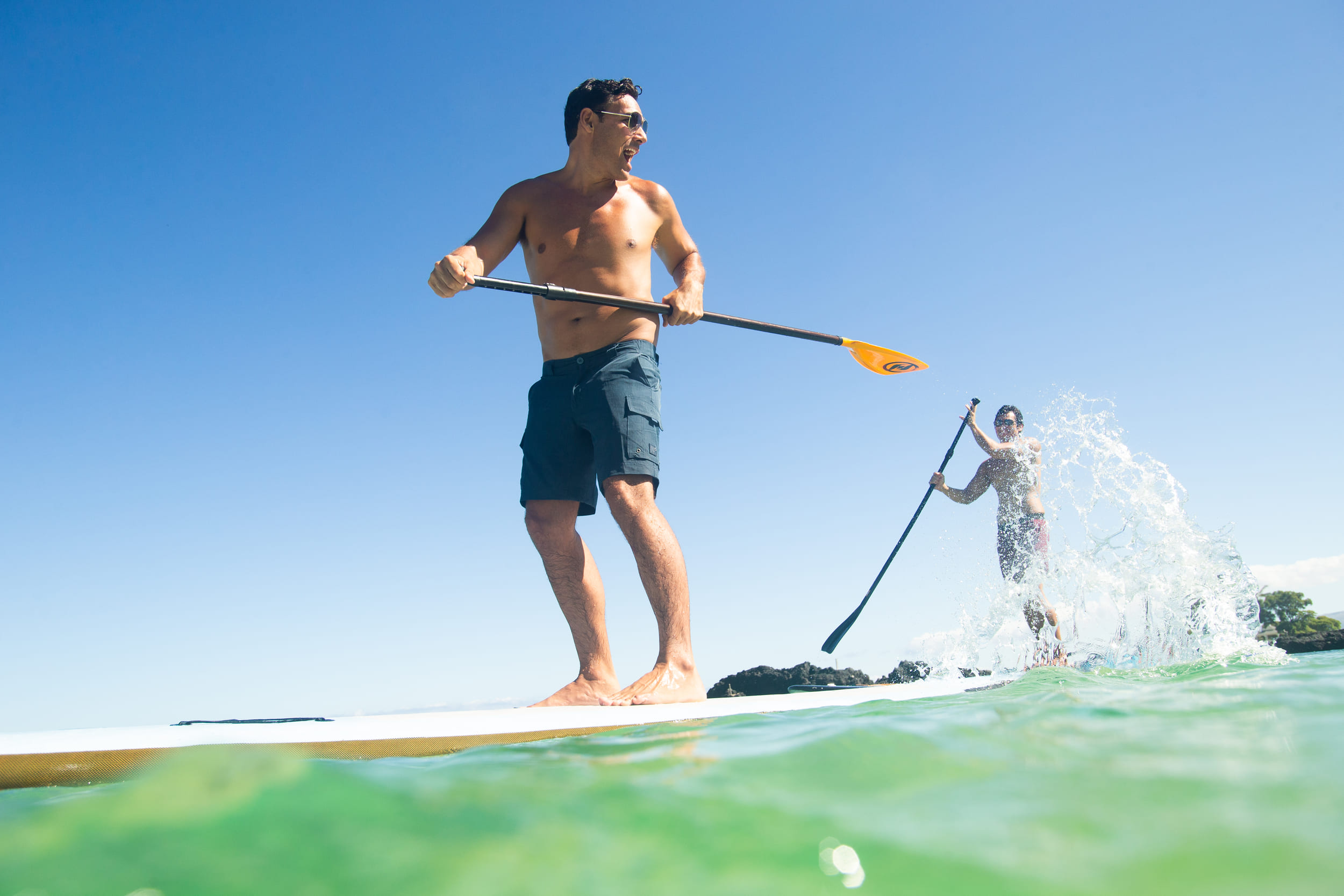 two men paddleboarding