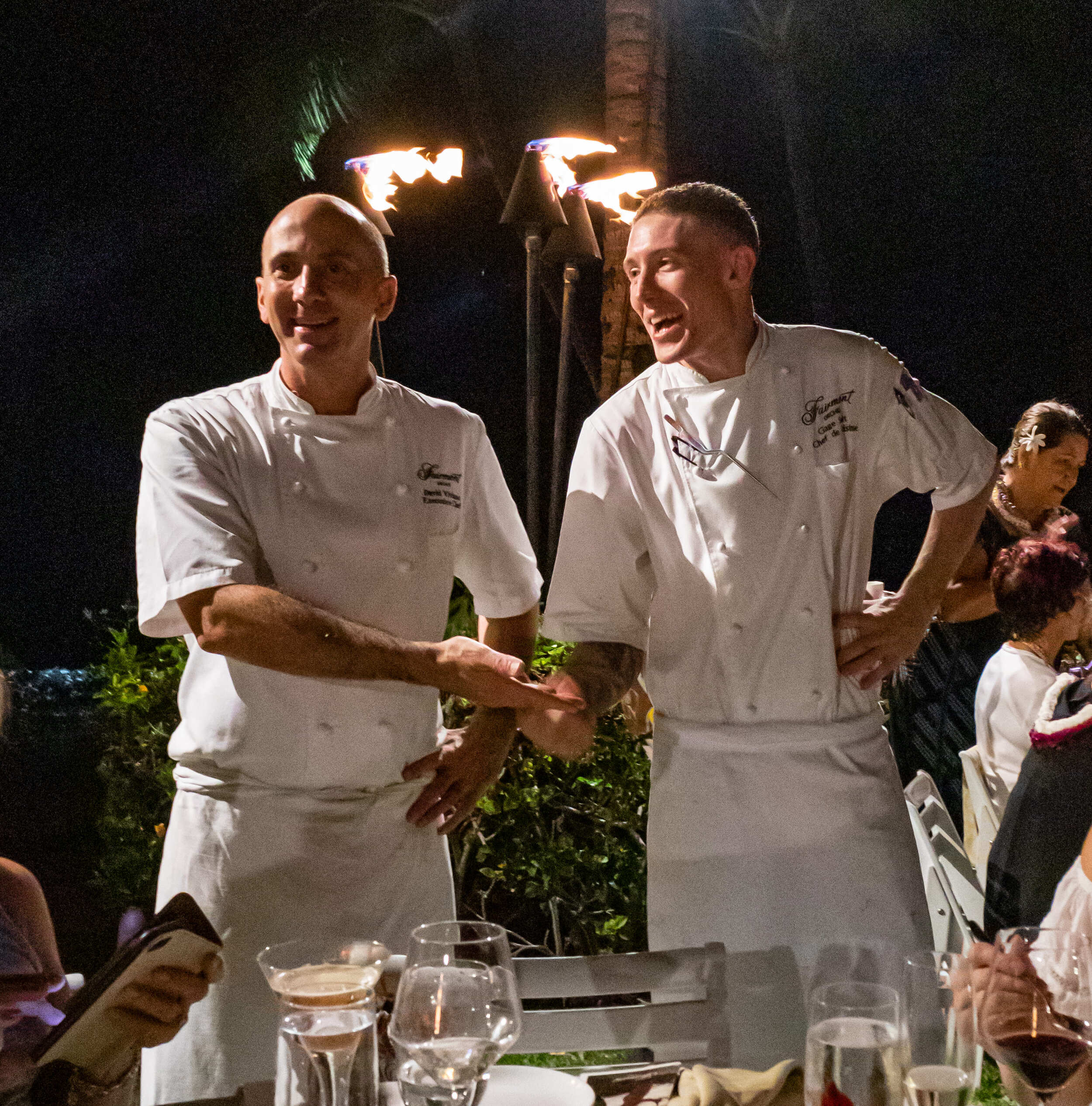 two chefs talking to the guests