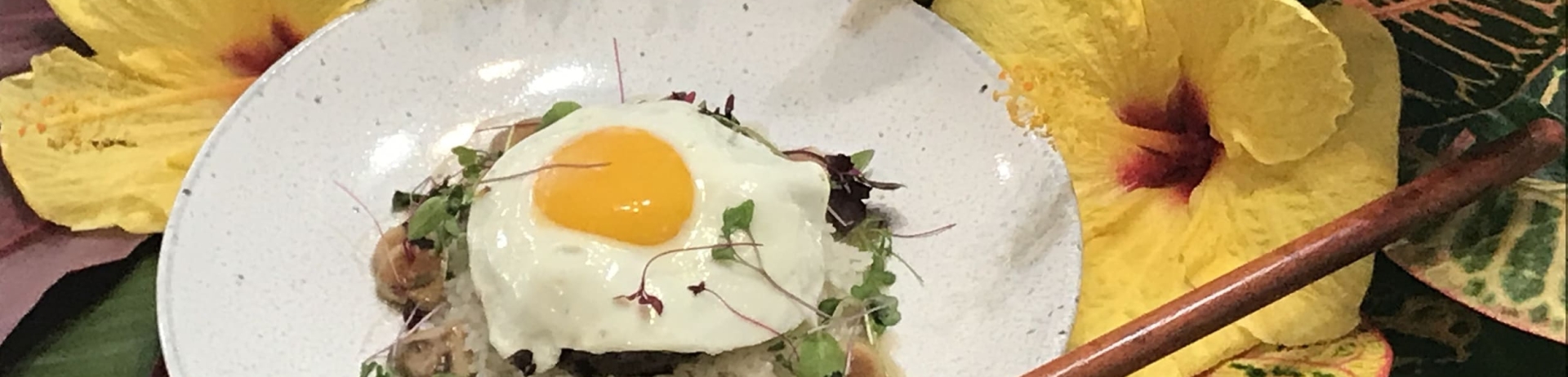 loco moco on a plate surrounded by flowers