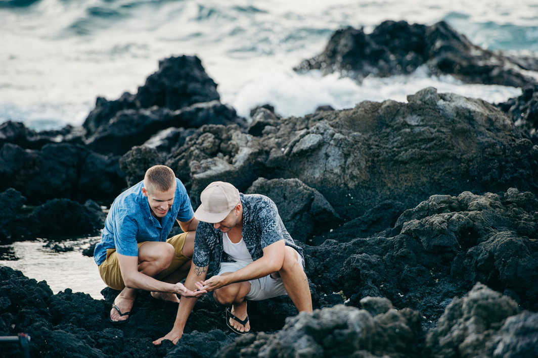 Two men looking at tide pool