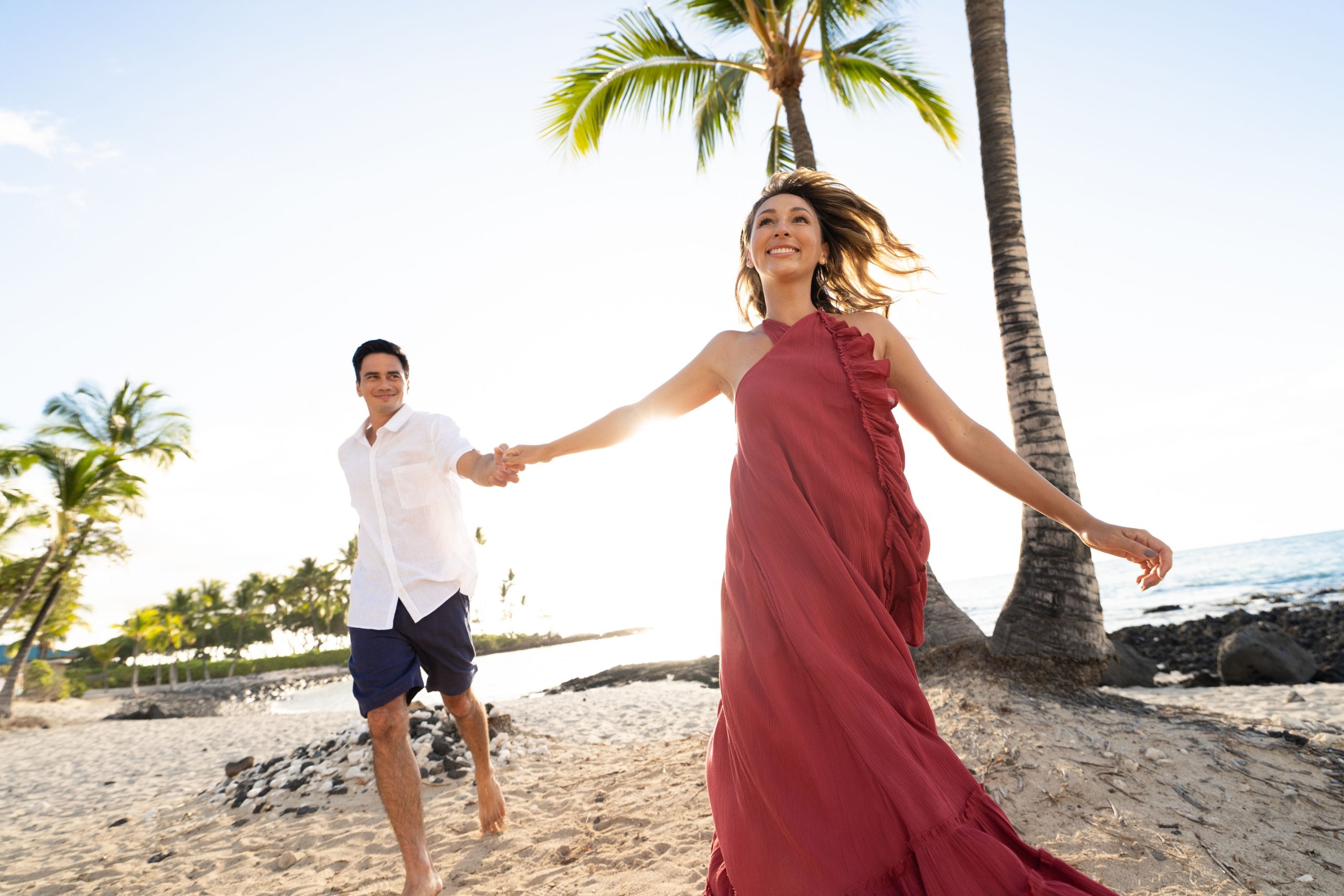 couple holding hands on the beach