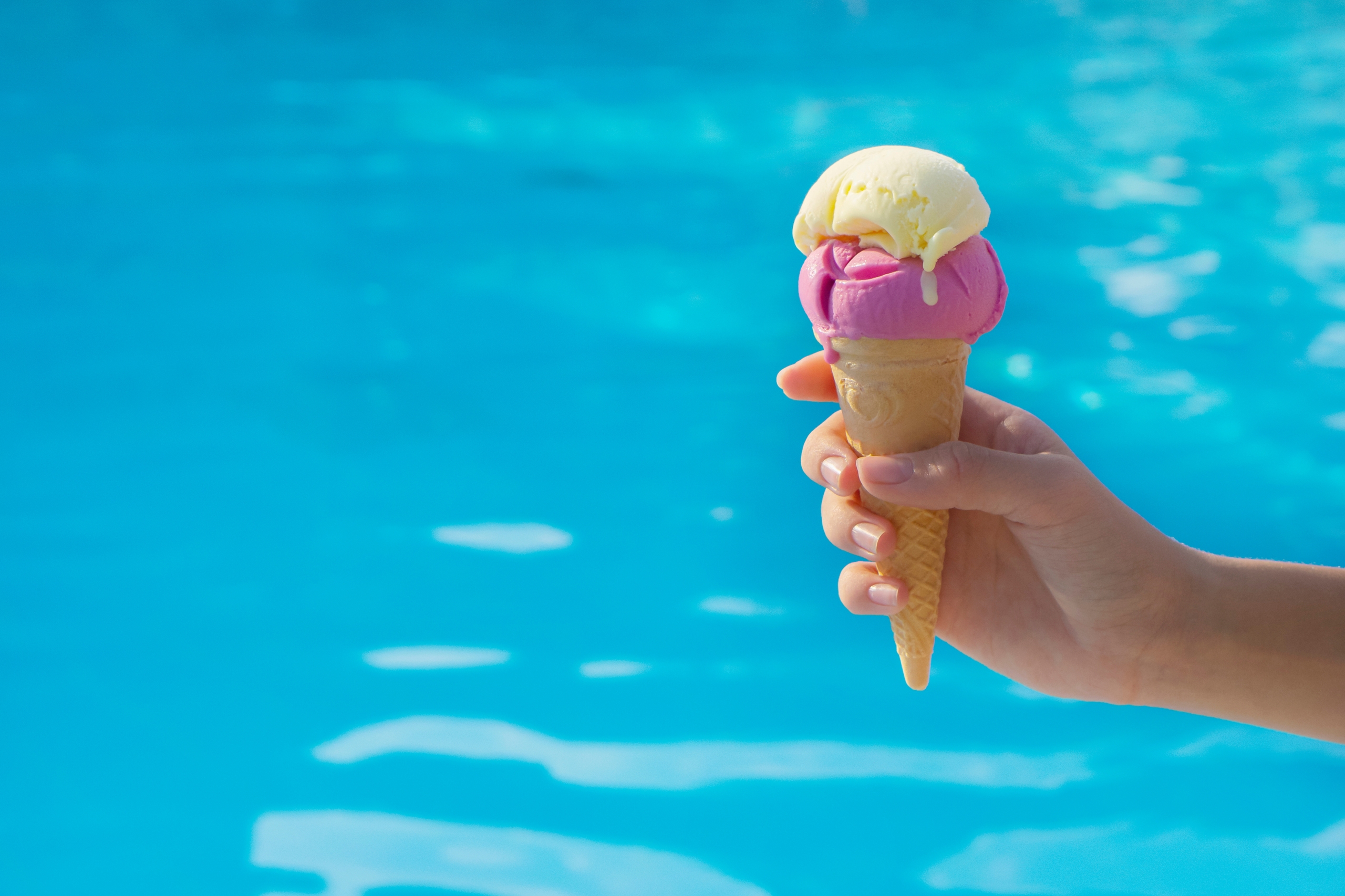 Ice cream on swimming pool background