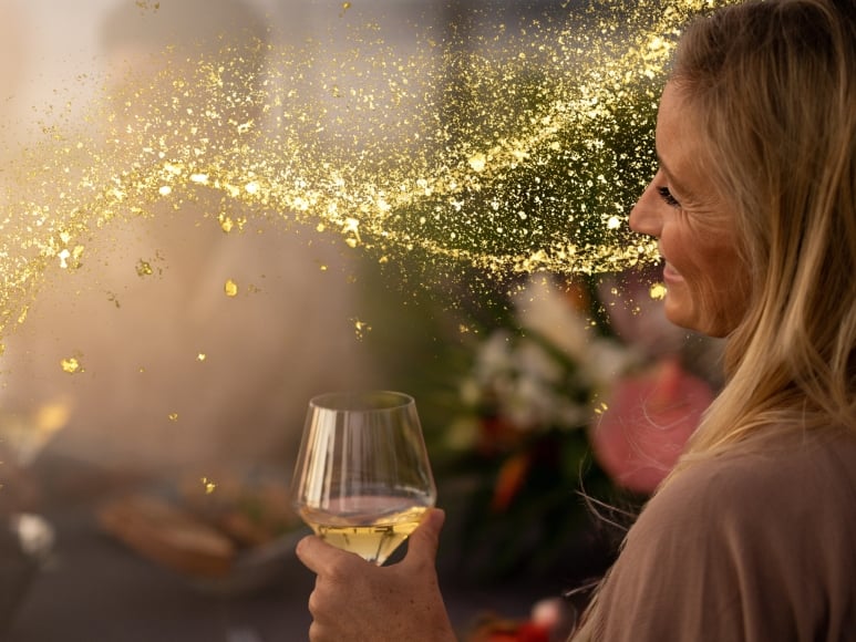 Woman holding wine glass at dinner