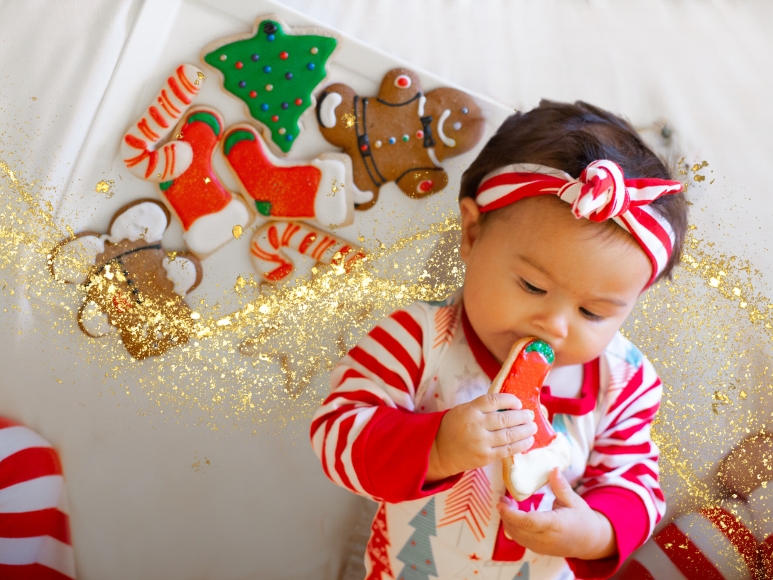 Baby holding holiday cookies