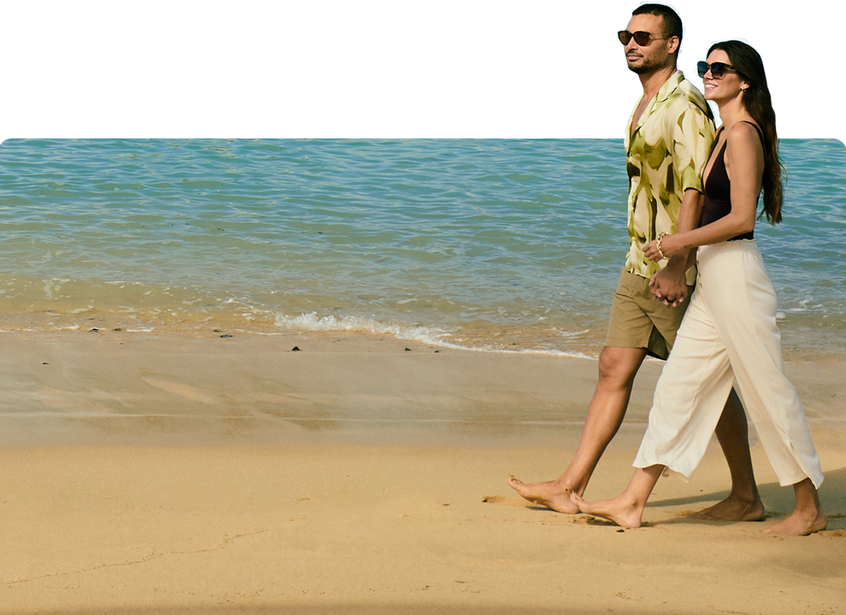 Couple walking down beach