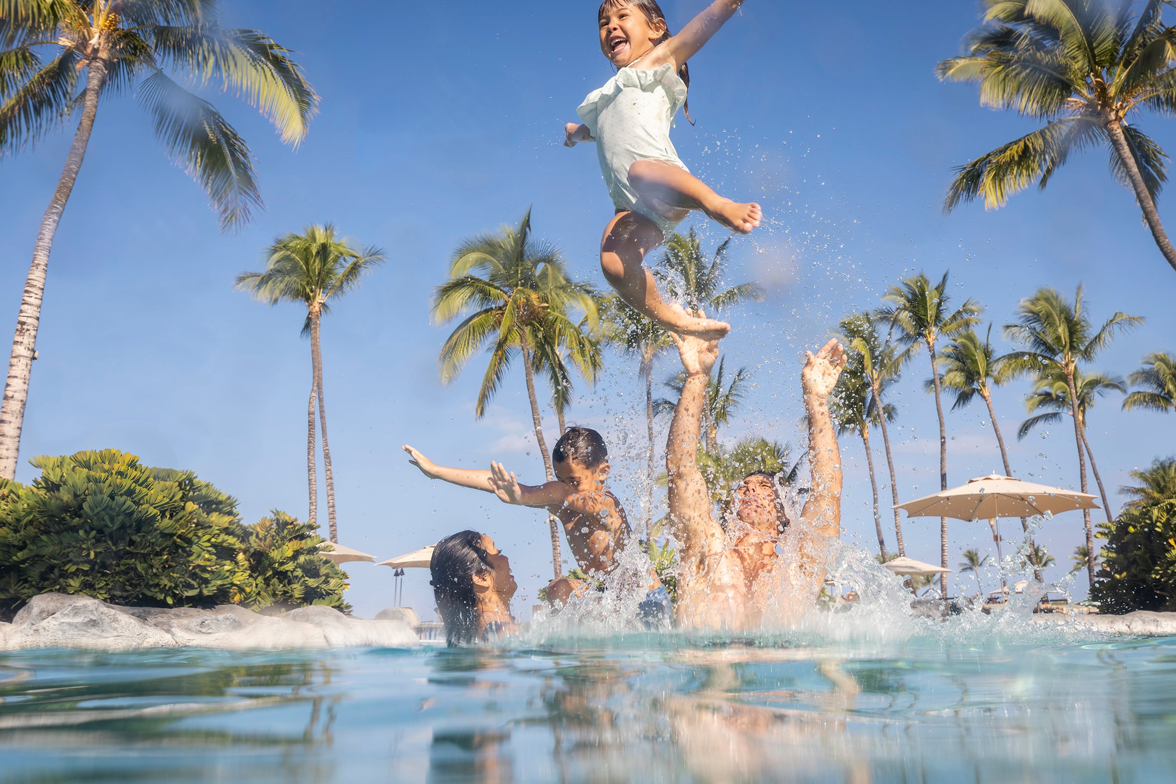 Family at oceanfront pool