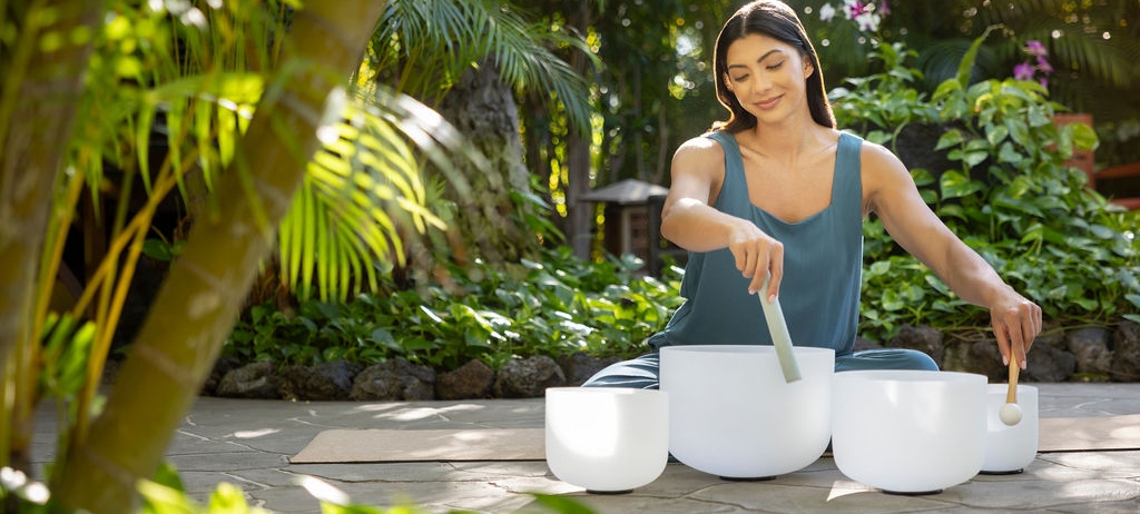 woman playing sound bath bowls